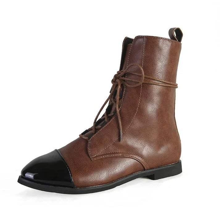 Model wearing brown vintage-inspired boots styled with slim trousers