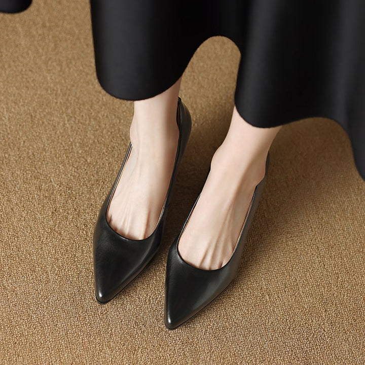 Venetia black block heel pump worn on foot, side profile view