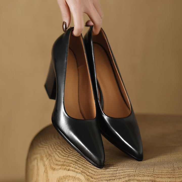 Venetia black block heel pump pair flat lay on neutral background