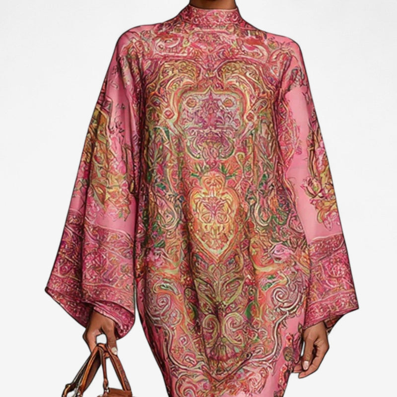Close-up detail of the pink printed caftan dress showing the bold colorful print and lightweight airy fabric