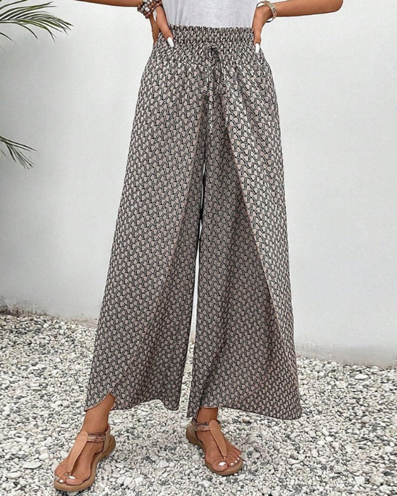 Green wide-leg geometric print trousers with flowy silhouette, front view