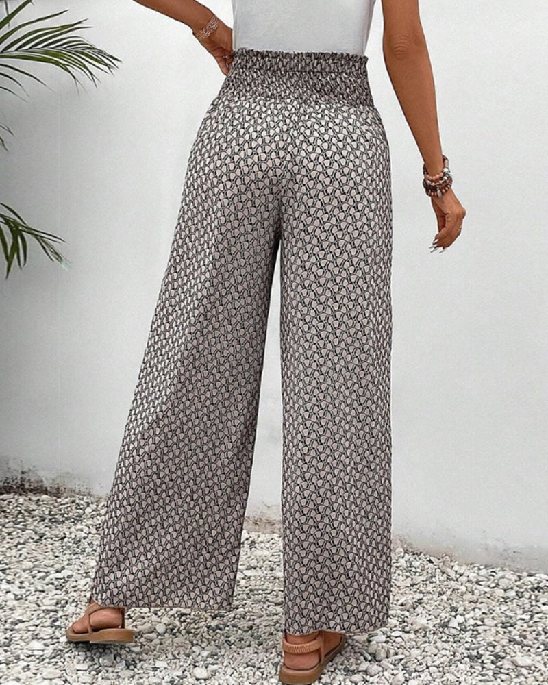 Close-up of bold geometric print fabric on wide-leg trousers in gray
