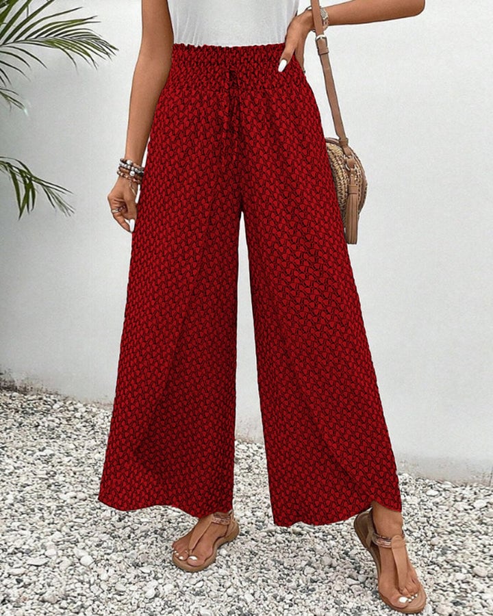 Wide-leg geometric trousers in green paired with a white tee, side view