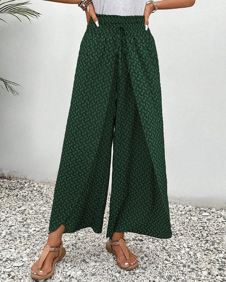 Side profile of relaxed wide-leg trousers in gray showing flowy drape