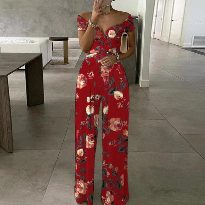 Front view of the Vera floral jumpsuit showing the crossover wrap neckline and flowing palazzo legs in blue leaf print