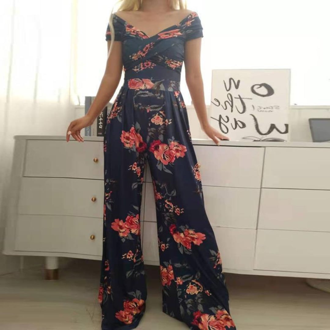 Full-length lifestyle shot of the Vera floral wide-leg jumpsuit styled with heeled sandals for a summer occasion