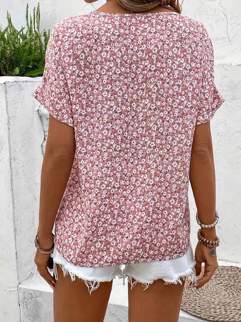Close-up of the delicate floral print and button detail on a chic airy blouse