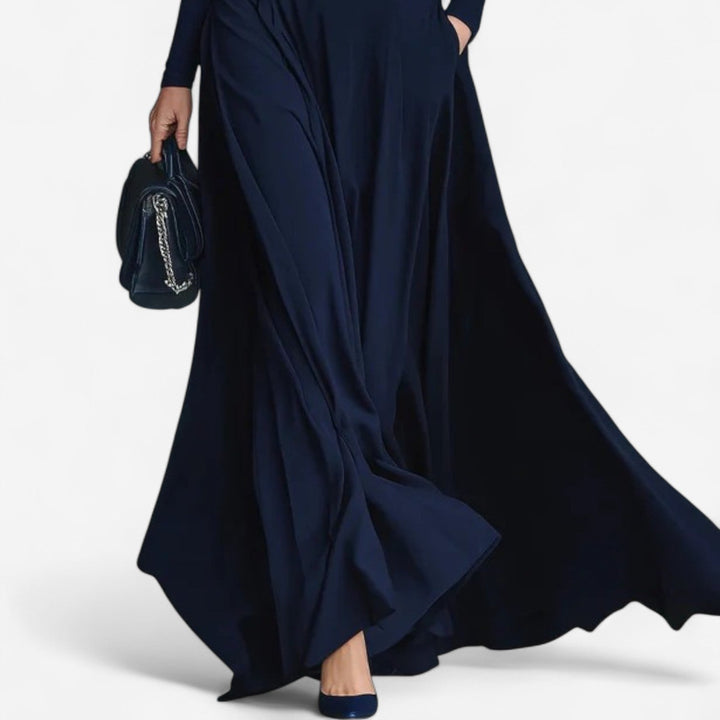 Close-up of the elegant high neck detail on a blue maxi dress with soft draped fabric