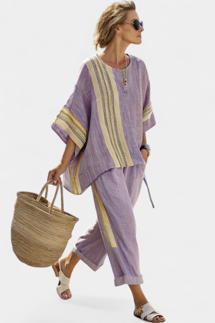 Woman wearing the Via linen two-piece set in purple with woven mustard stripe trim on the oversized top and tapered pants