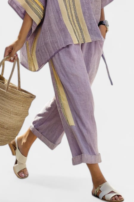 Detail shot of the Via linen pants rolled cuffs and coordinating stripe trim at the ankle