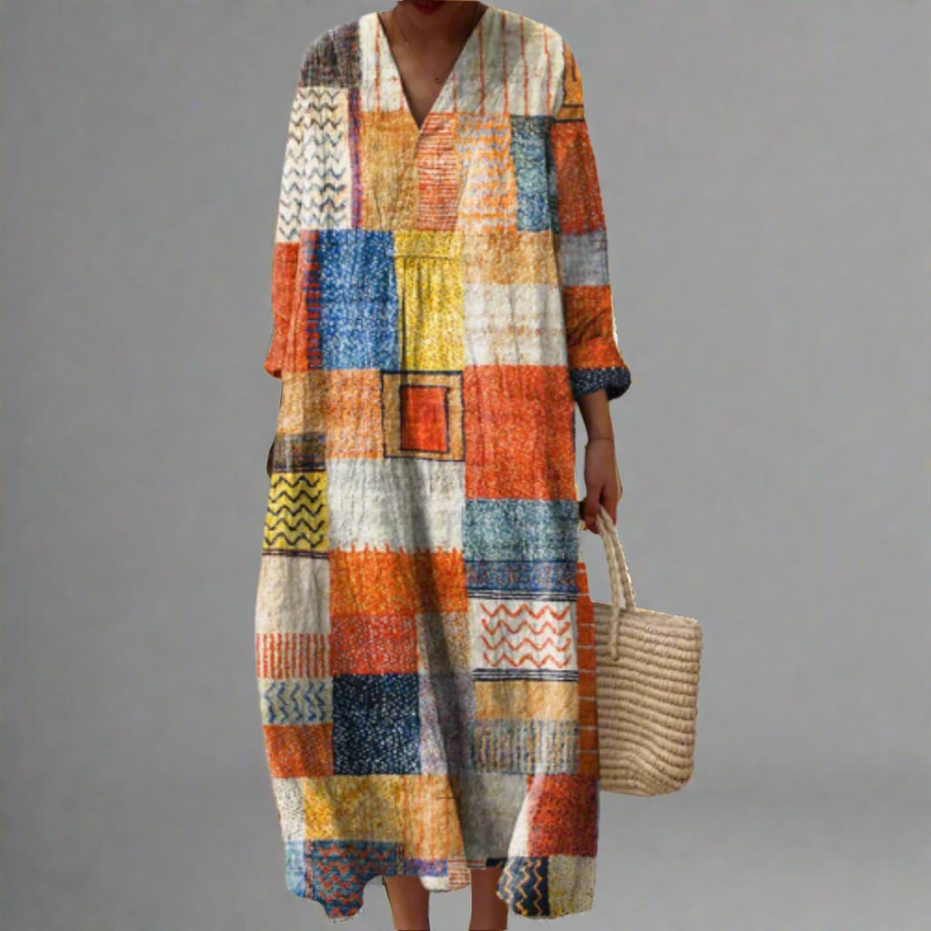 Model wearing the Vianna elegant geometric dress featuring a bold dream-inspired print and flowing silhouette