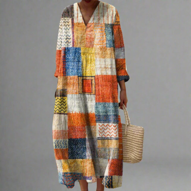Model wearing the Vianna elegant geometric dress featuring a bold dream-inspired print and flowing silhouette