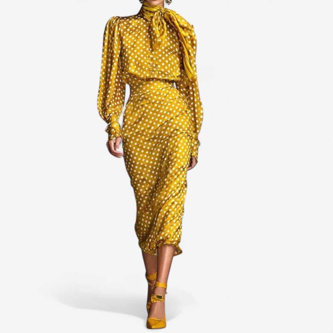 Woman wearing the Vicky classic elegant gold dress, showing the coordinated top and bottom silhouette