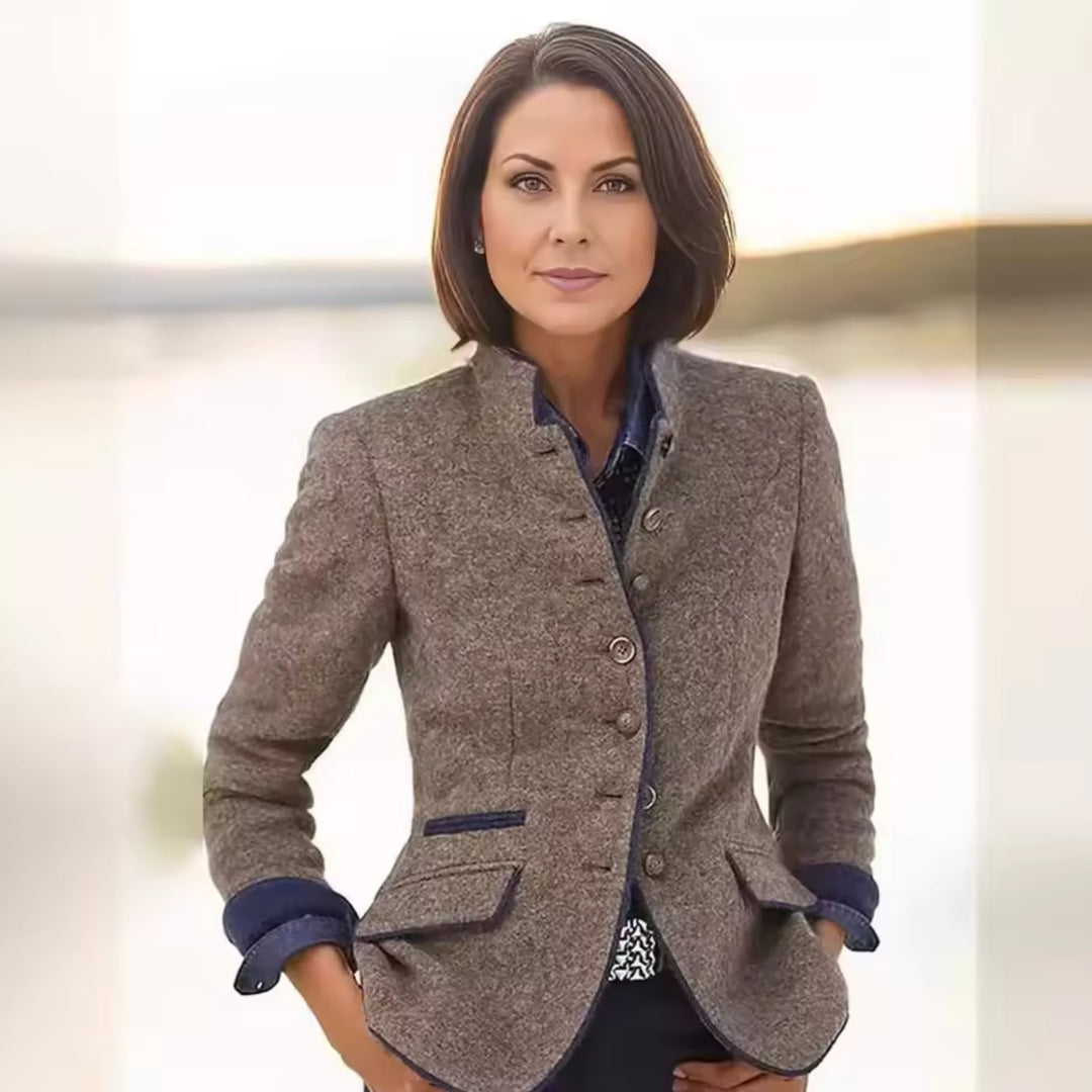 Woman wearing the Victoria handcrafted jacket in brown, showcasing its tailored silhouette and elegant drape