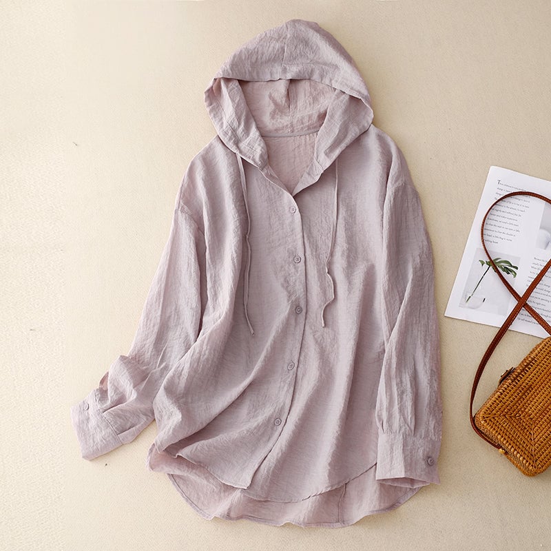 Woman wearing a lightweight purple button-front hoodie with a soft hood, relaxed fit, and clean minimalist finish