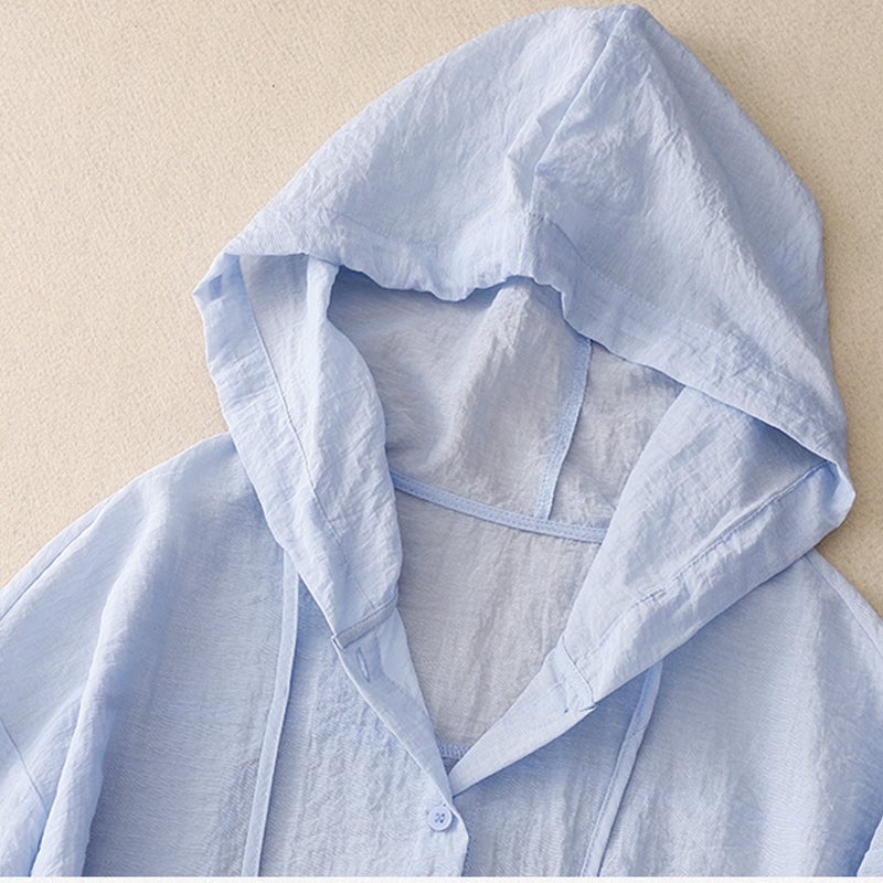 Front view of the lightweight button hoodie in white, styled open over a casual outfit with clean hem details