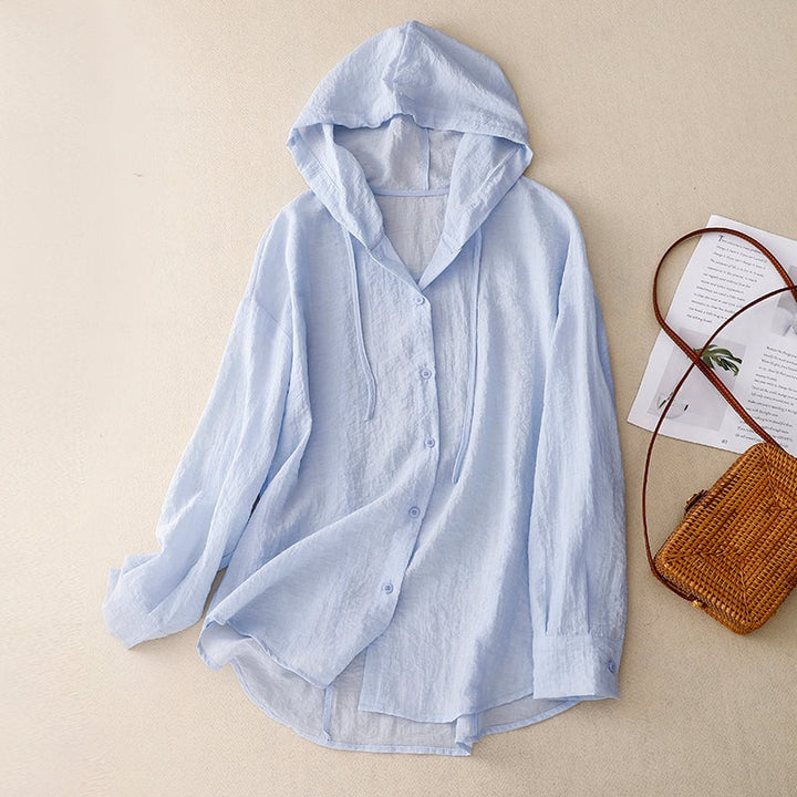 Flat lay of the lightweight button hoodie in multiple colors — purple, white, and blue — on a clean background