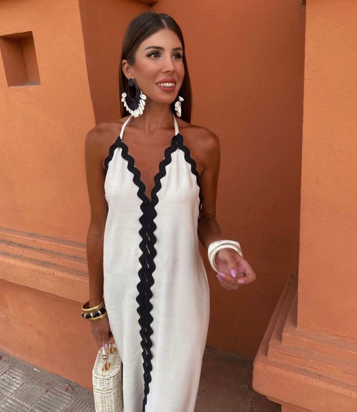 Side profile of the Victoria wrap dress in black highlighting the elongated silhouette and graceful fabric drape