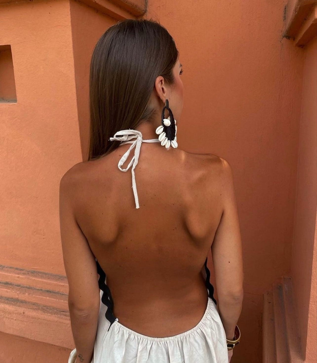 Close-up detail of the Victoria wrap dress neckline and shoulder shaping in white