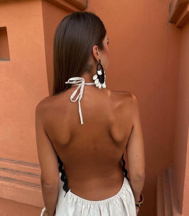 Close-up detail of the Victoria wrap dress neckline and shoulder shaping in white