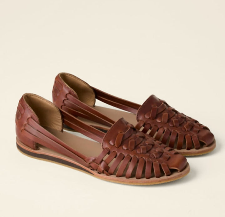 Victoria woven flat sandals in brown showing closed-toe silhouette and flat sole, side view