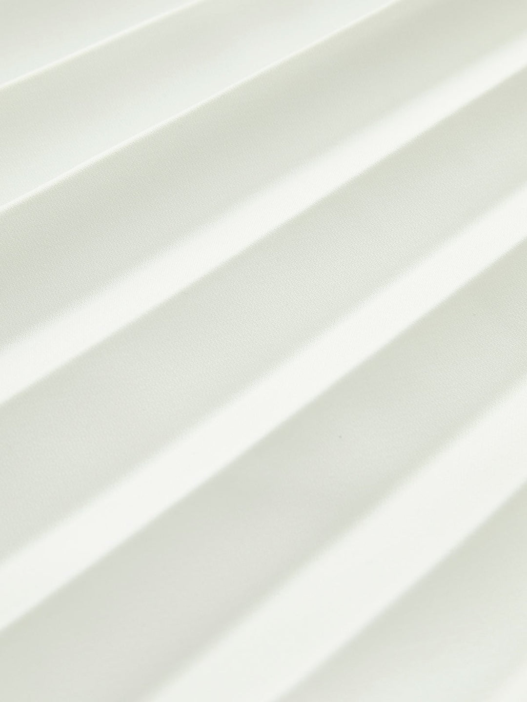 Detail shot of the accordion pleats and angled waistline on the Vienna maxi dress