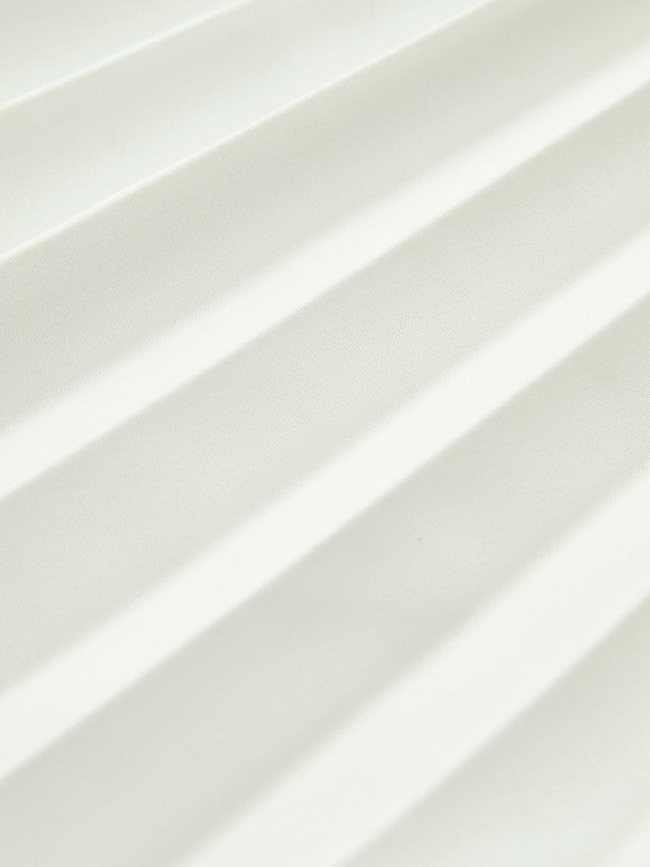Detail shot of the accordion pleats and angled waistline on the Vienna maxi dress