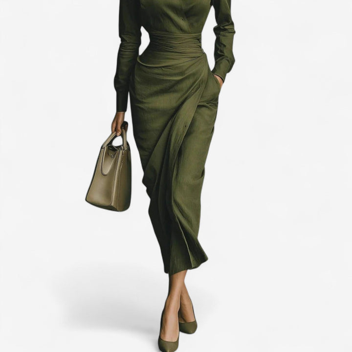 Close-up detail of the dark green wrap dress fabric and neckline drape