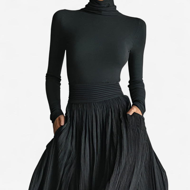 Close-up detail of black maxi dress fabric showing soft, lightweight drape and high waistline