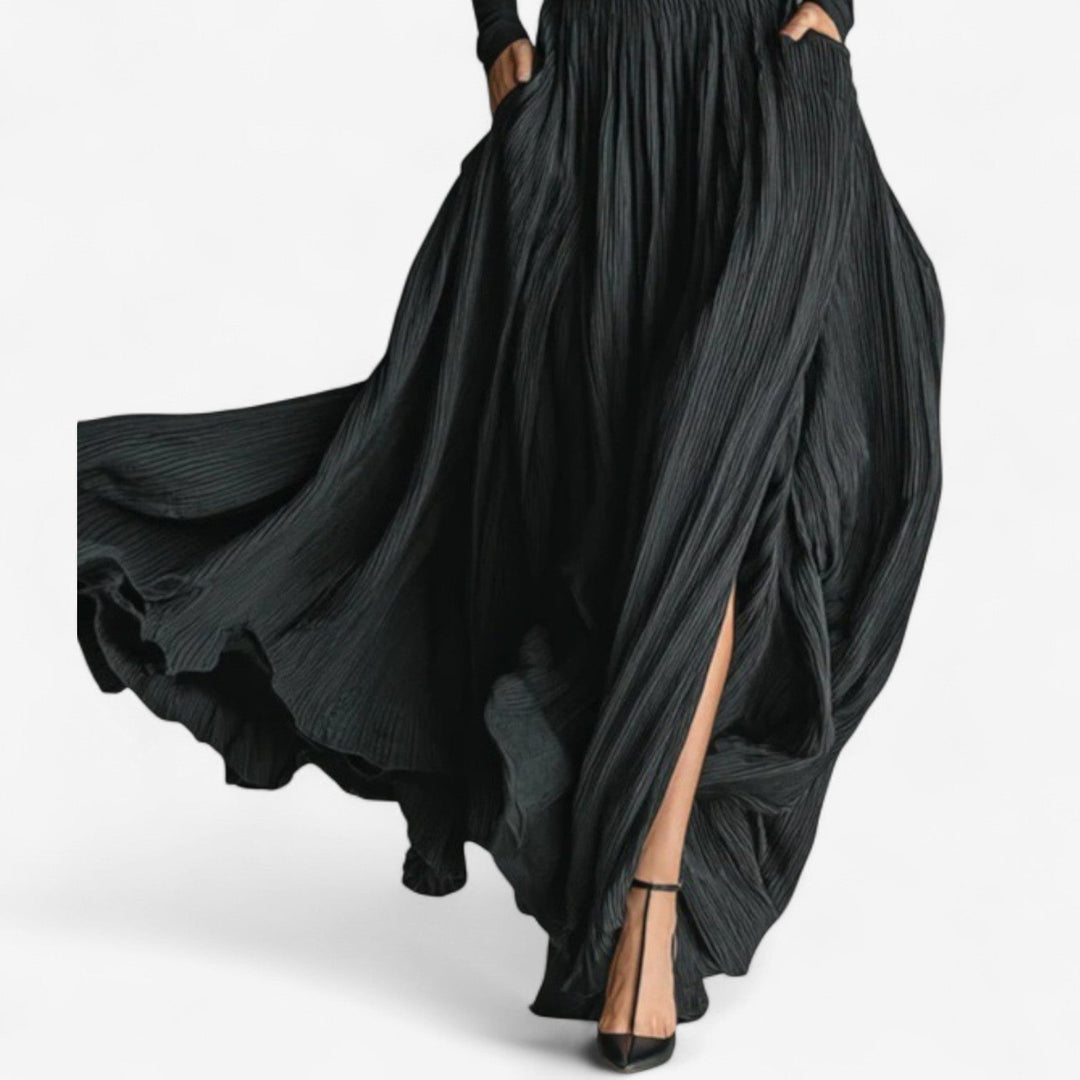 Model styled in black maxi high dress, showcasing floor-length silhouette and graceful movement