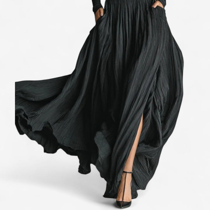 Model styled in black maxi high dress, showcasing floor-length silhouette and graceful movement