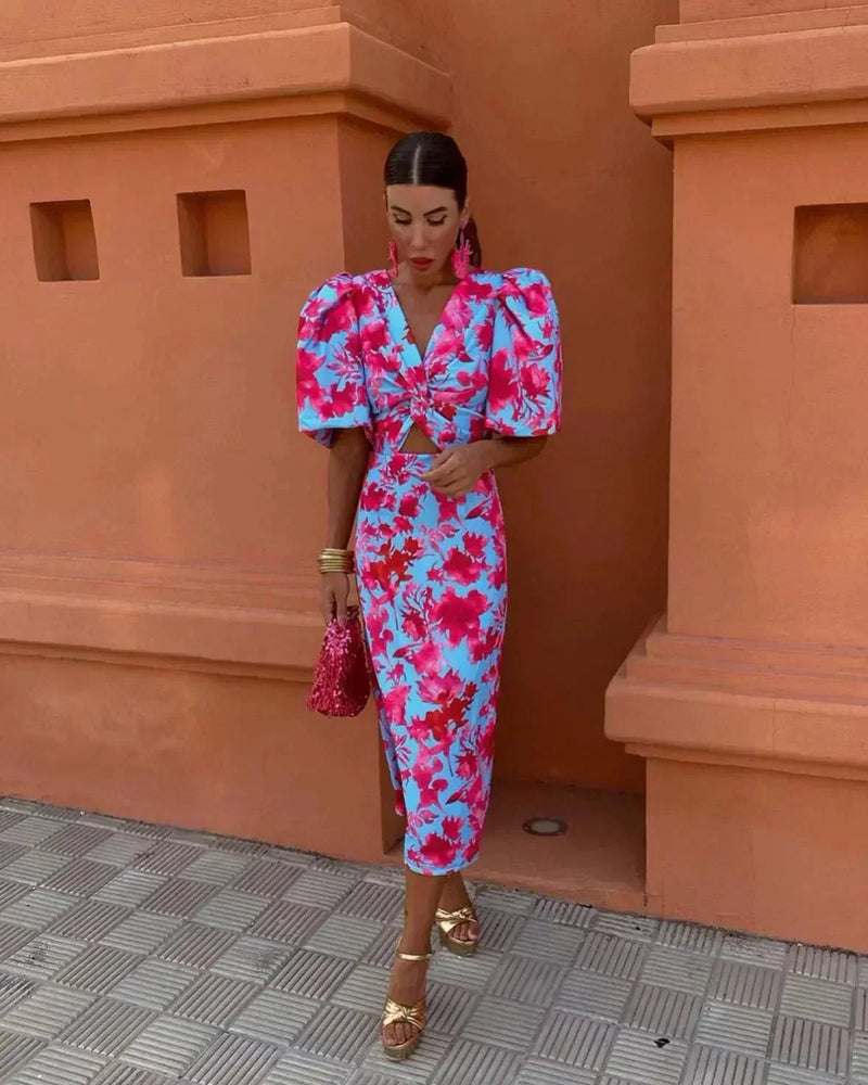 Woman wearing the Violette women's wedding guest midi dress in a flattering silhouette with smooth drape and shoulder-framing neckline
