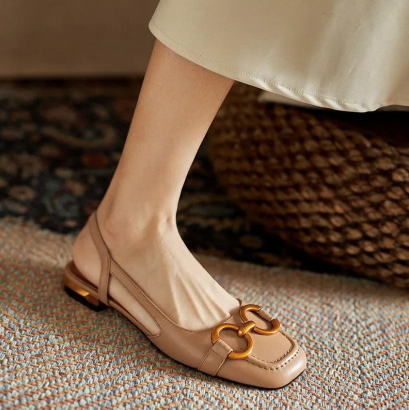 Flat lay of Virginia sandals in khaki on a light surface showing color and overall silhouette