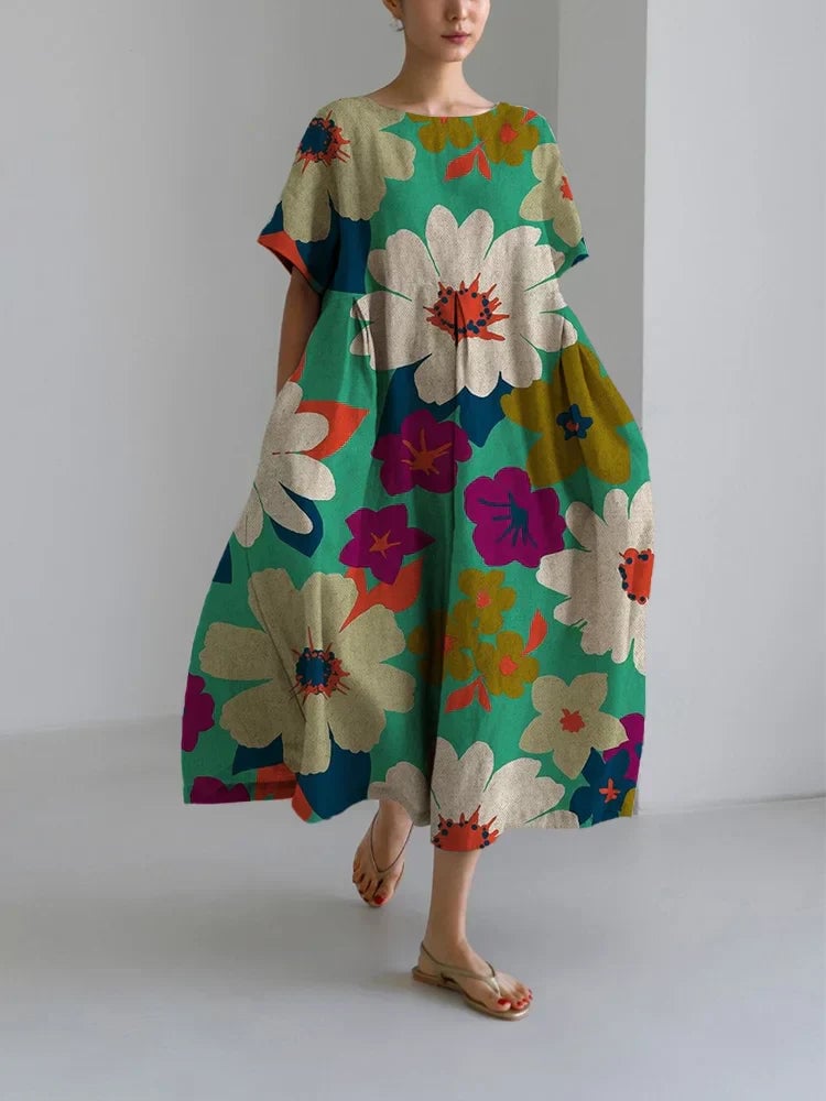Woman wearing the Vittoria midi floral dress with a vibrant all-over floral print and relaxed midi-length silhouette