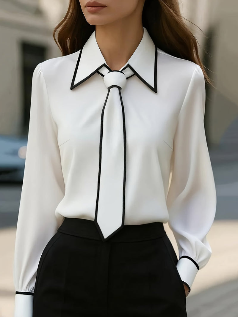 Women's white long sleeve tie neck blouse with black contrast collar, piping, and detachable neck tie, front view