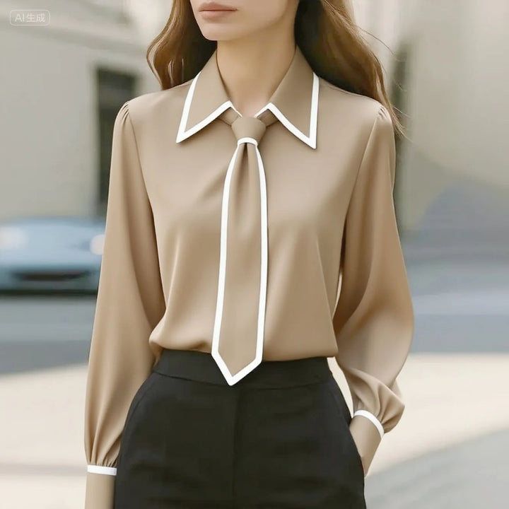Close-up of the contrast-trimmed pointed collar and detachable tie detail on the Vivian blouse in white