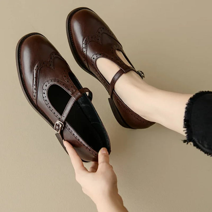 Vivian T-strap Mary Jane shoes in black with low block heel and brogue toe detailing, front view