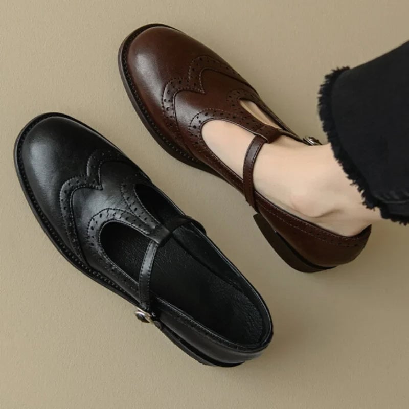 Vivian T-strap Mary Jane shoes in black showing adjustable buckle strap detail, side view