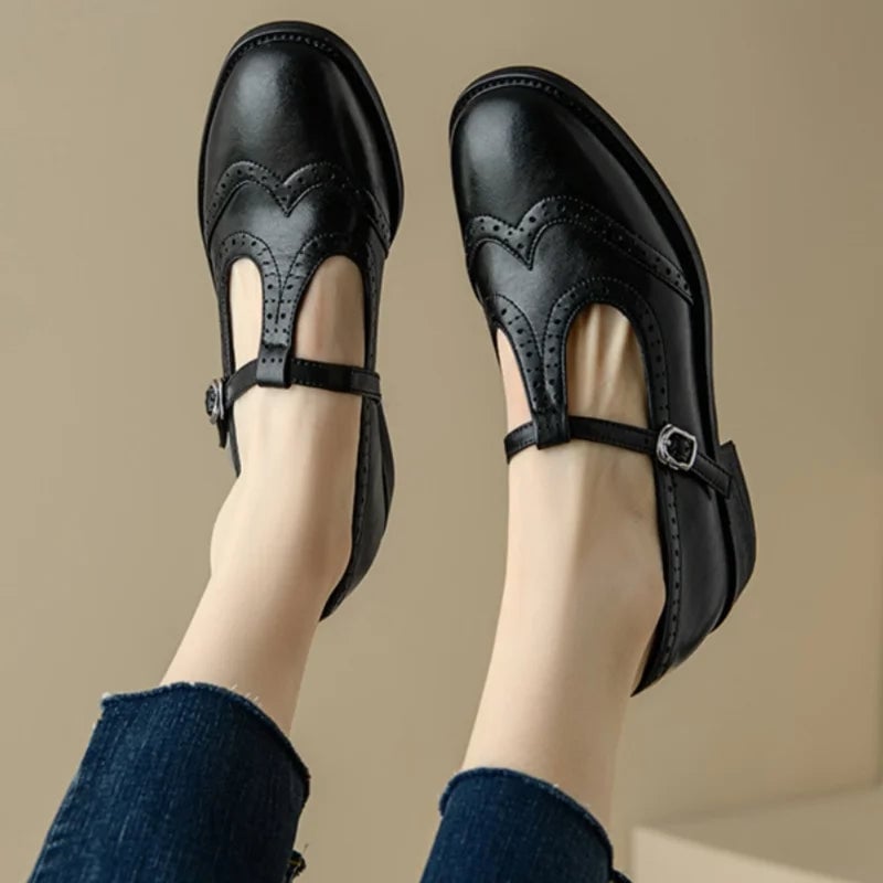 Vivian T-strap Mary Jane shoes in black, top-down view highlighting perforated brogue trim