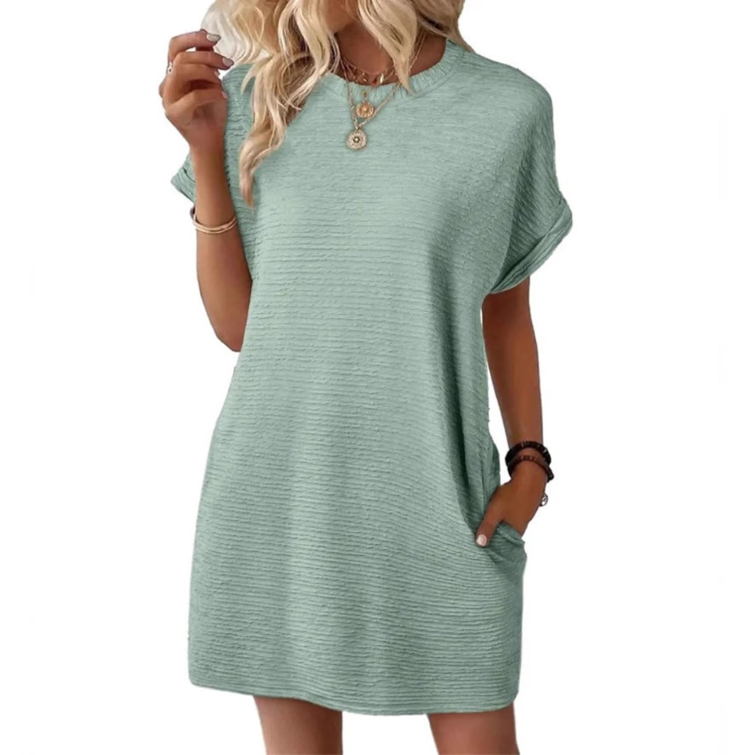 Side view of the Vivid mini dress in Light Green highlighting the clean streamlined silhouette