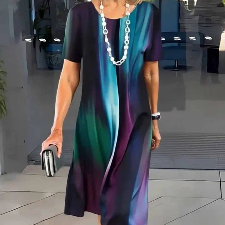 Model posing in the Vivid midi dress in red print, showing skirt movement