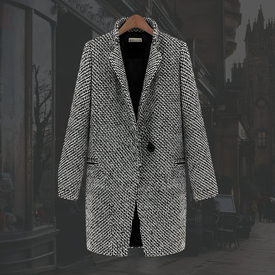 Woman wearing the Vivienne long winter coat with a sleek, elongated silhouette in a neutral color