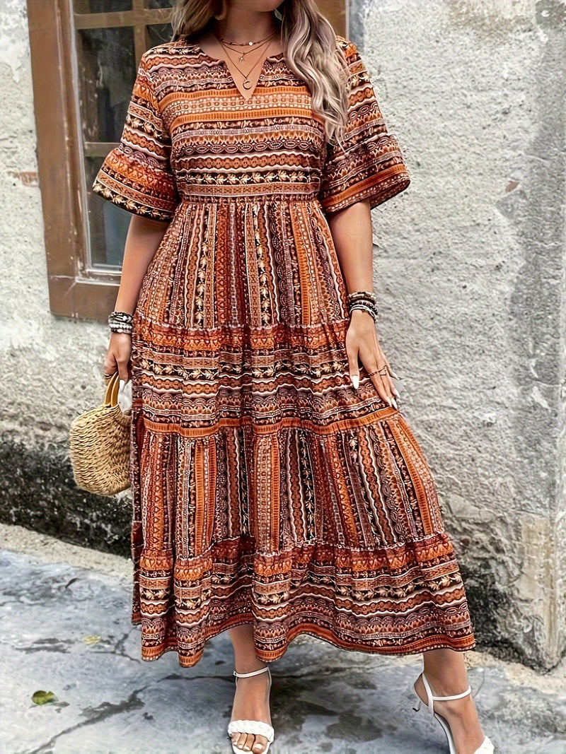 Close-up of Vivienne dress fabric showing rich ethnic-inspired print detail in green and brown