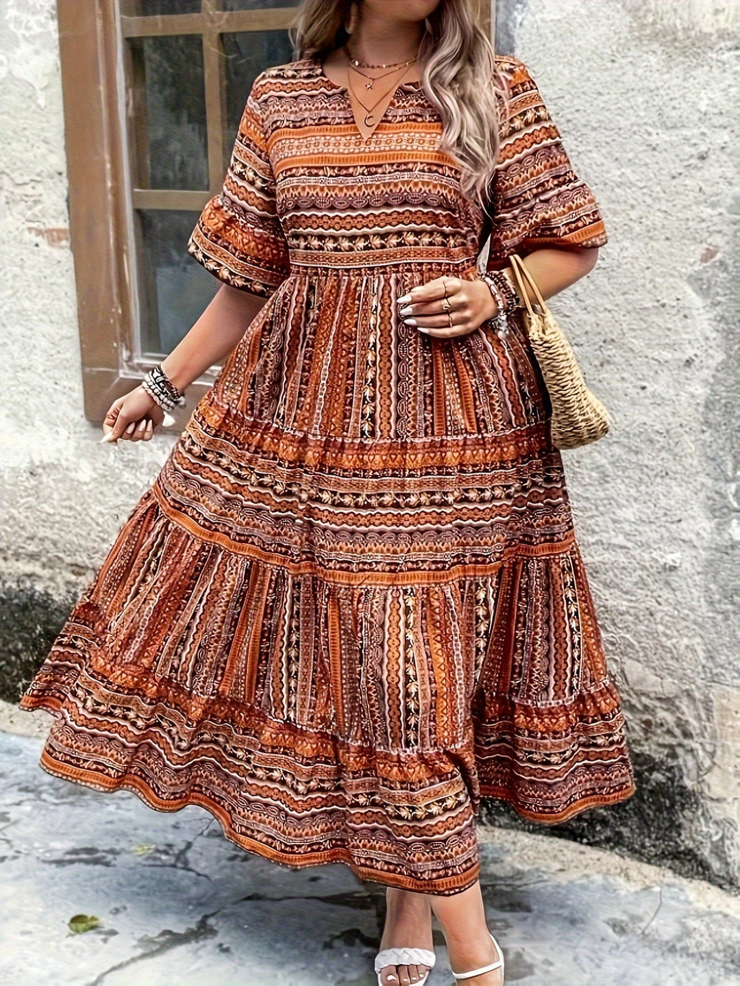 Side view of Vivienne dress in brown ethnic print showing drape and flow