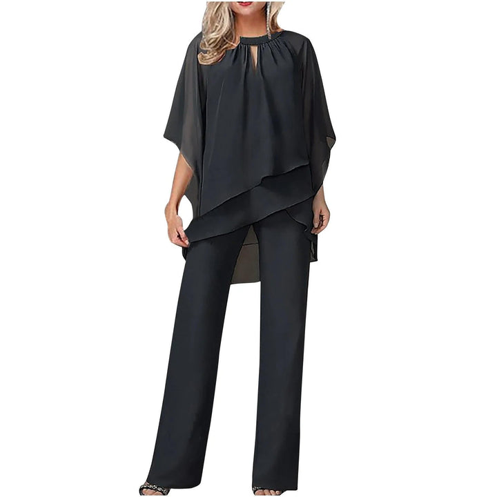 Front view of the Vivienne wide leg pantsuit in black showing asymmetric chiffon overlay and elbow-length batwing sleeves