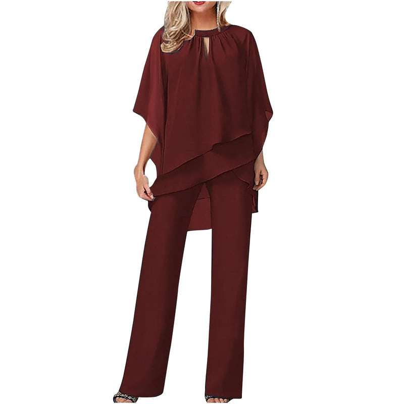 Close-up detail of chiffon overlay drape and batwing sleeve on the Vivienne pantsuit in white