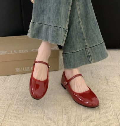 Side view of Vivienne patent mary jane shoes showing rounded toe and cushioned low block heel in red