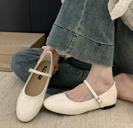 Vivienne patent mary jane shoes in beige with buckle ankle strap detail on a clean background