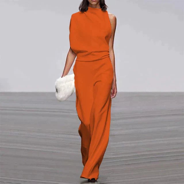 Woman wearing the Vivienne sleeveless wide-leg jumpsuit with mock turtleneck in bold orange, full-length front view