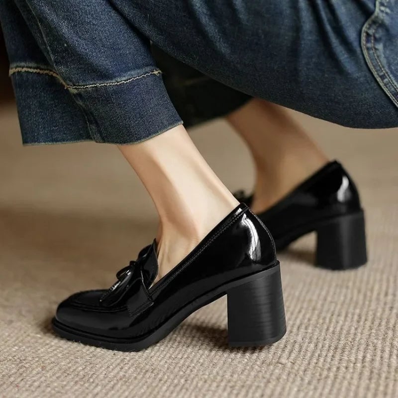 Close-up of fringe tassel accent on Vivienne black loafer pump